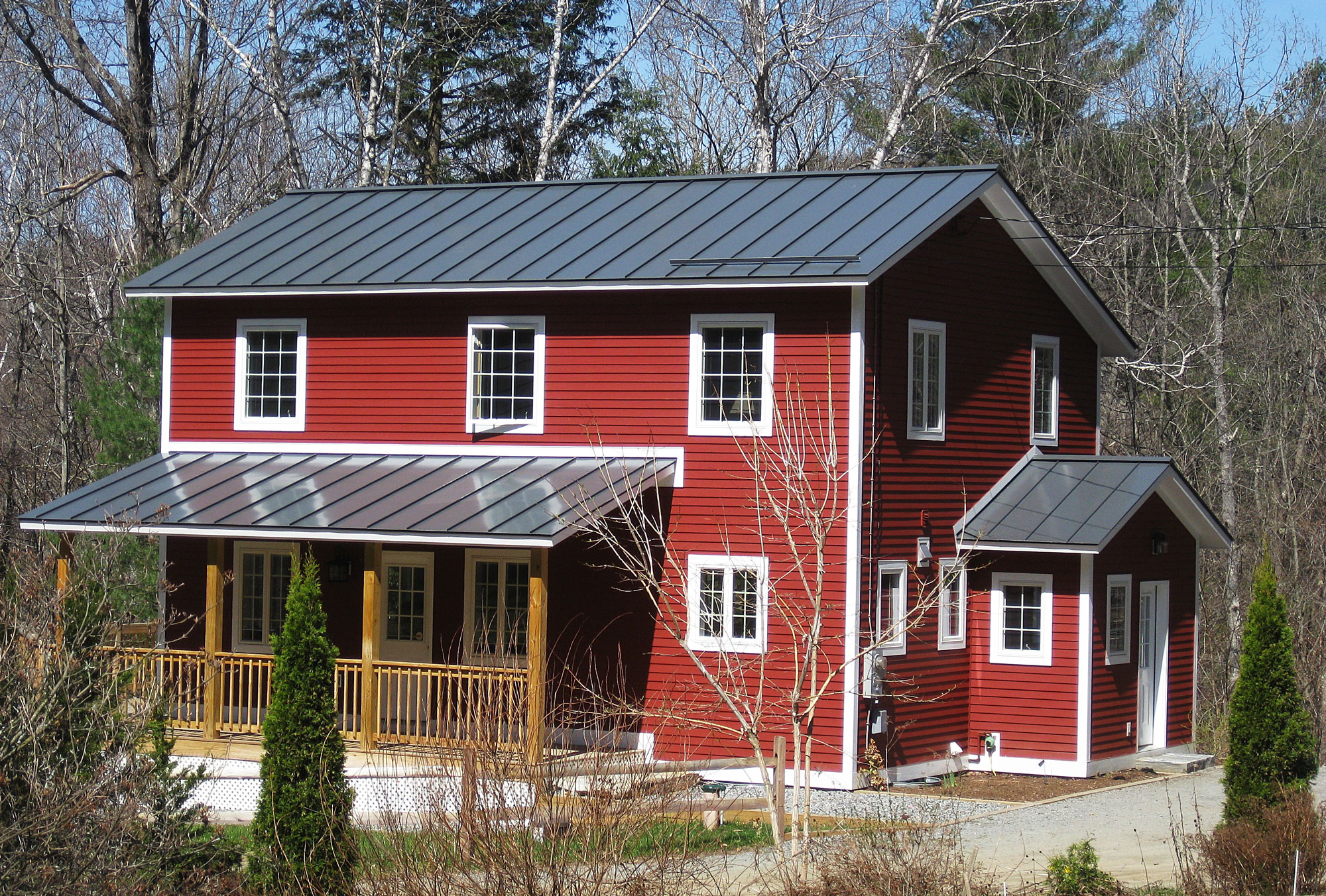 Red Siding 2 story home with metal roofing